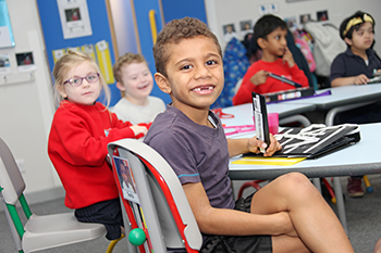 Young boy with developmental language disorder in classroom