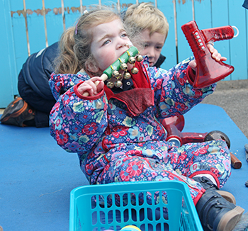 Young with girl playing with noisy toys