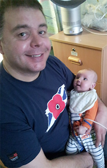 Colin holding baby Tom