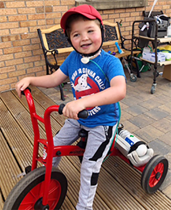 Tom riding a tricycle
