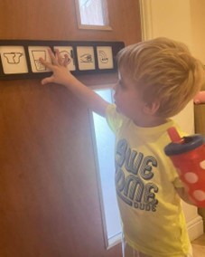 Young boy playing with Makaton Symbol cards
