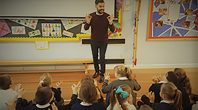 Steven signing with pupils