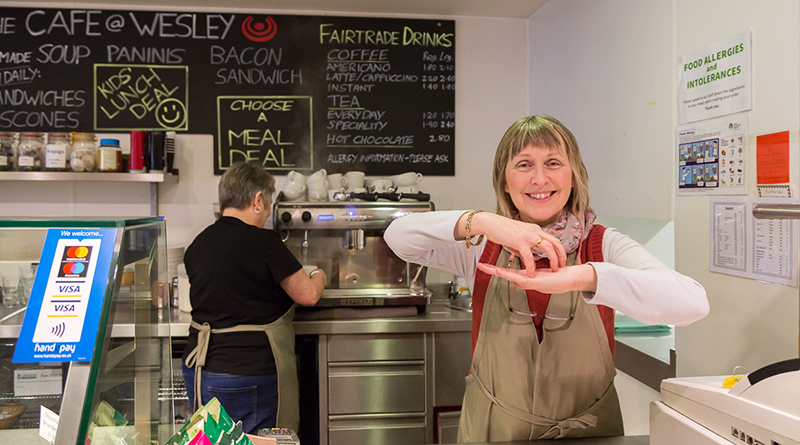 Woman signing Cake in a cafe
