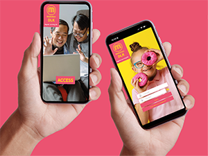 Two hands, each holding a mobile phone showing the Makaton DLK App