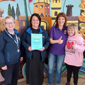 Ana and Maria, with staff from the Millennium Forum holding their Makaton Friendly certificate
